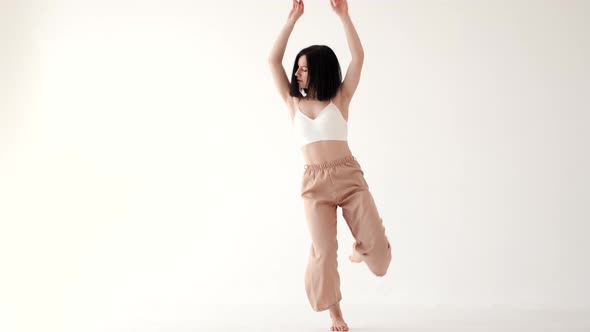 Woman in Beige Costume Dancing Contemp on White Background