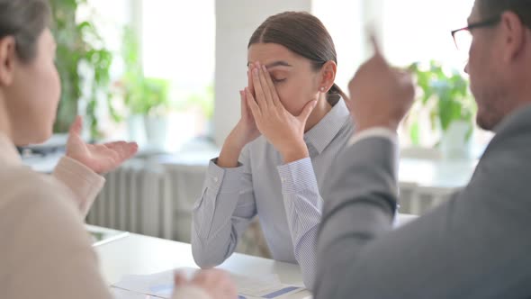 Angry Male and Female Colleagues Scolding Latin Female Colleague