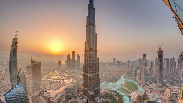 Paniramic Skyline View of Dubai Downtown During Sunrise with Mall Fountains and Burj Khalifa Aerial