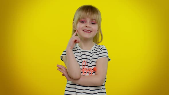 Smiling Pretty Little Blonde Teen Child Kid Girl Posing Isolated on Yellow Studio Background