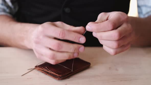 The Tanner Is Stitching a Hand-made Leather Wallet