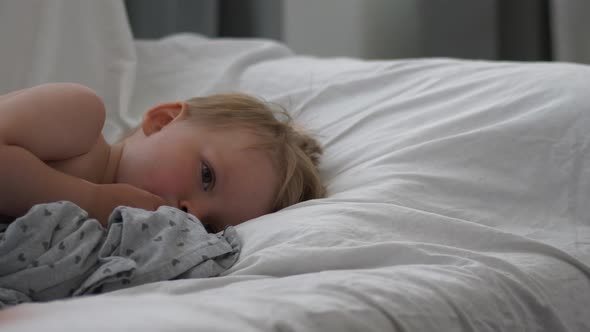 Sick Toddler boy sleeping on the couch, handheld shot