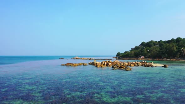 Aerial drone shot seascape of idyllic bay beach trip by blue water and white sand background of a da