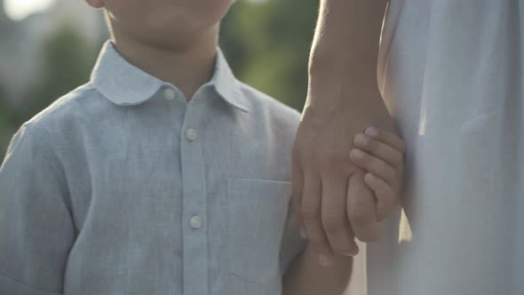 Closeup Unrecognizable Little Boy Taking Mother's Hand Sunlight