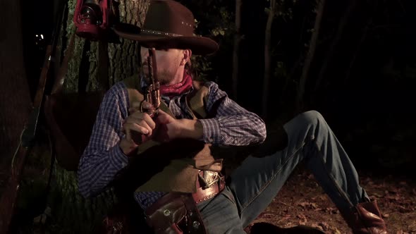 Cowboy with a Handgun in the Forest at Night