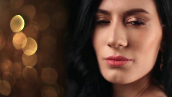 Face of Asian Woman Jewelry Earrings Posing at Black Golden Bokeh