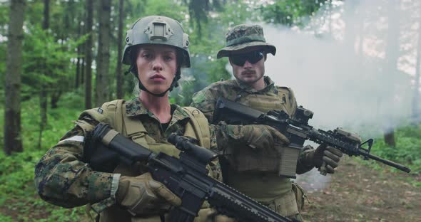 Squad of Soldiers Patrolling Across the Forest Area Team with Male and Female Soliders in Dense
