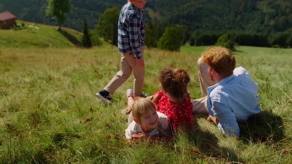Happy Family Relaxing Grass Mountain Slope