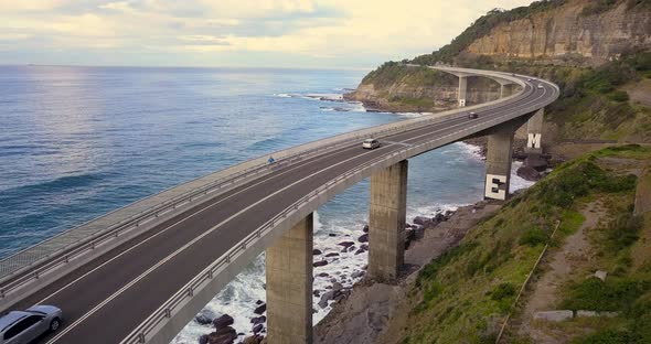 Cars Driving Along Sea Cliff Bridge