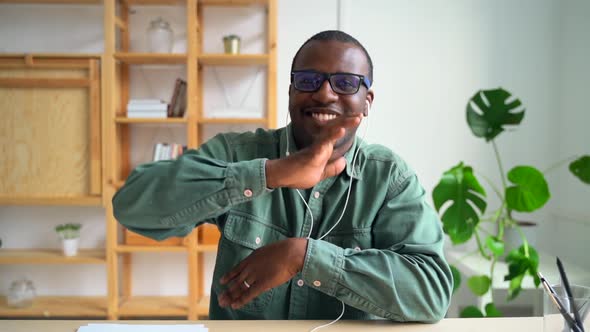 Young Businessman Having Fun and Listening to Music at Table in Modern Office Spbas