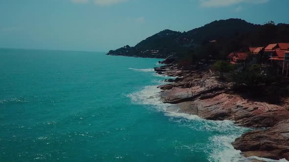 Aerial View of Island Beach with Willa and Rocky Coastline