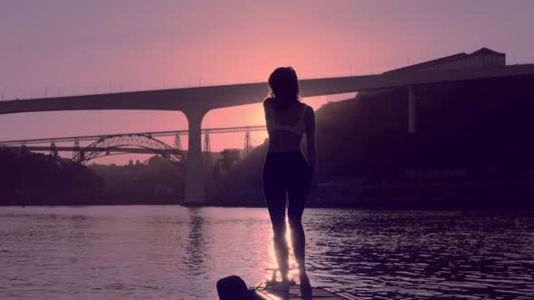 Young Dancing Woman on River Boat Station Porto in Sunset