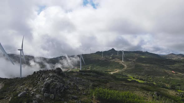 Eolic turbines in absence of wind on cloudy day at Caramulo in Portugal. Aerial forward