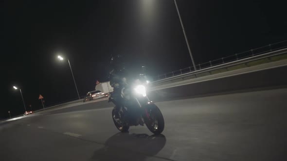 Woman Riding on Modern Sport Motorbike at Highway at Night