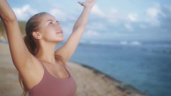 Portrait of Woman Practices Yoga, Concentrates on Breathing at Beach, Slow Motion