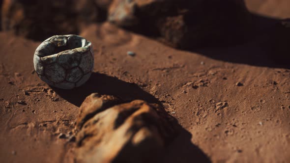 Old Football Ball on the Sand Beach alt