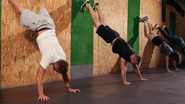 Athlete Walks on Hands While Standing Upside Down Near Wall