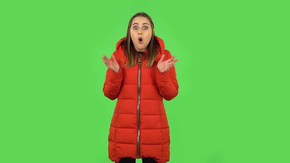 Lovely Girl in a Red Down Jacket Frustrated and Saying Oh My God, Being Shocked. Green Screen