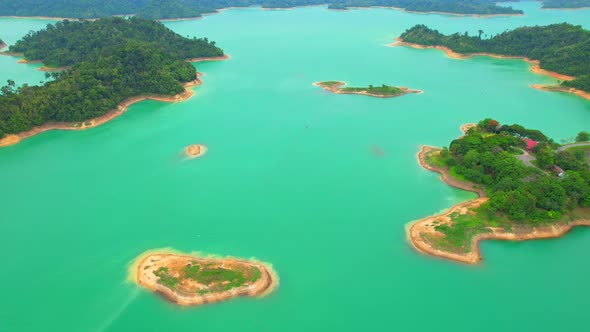 An aerial view from a drone flying over a dam, beautiful turquoise water