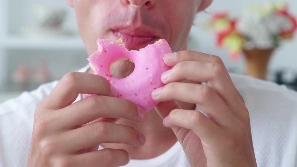 Man Biting an Appetizing Donut