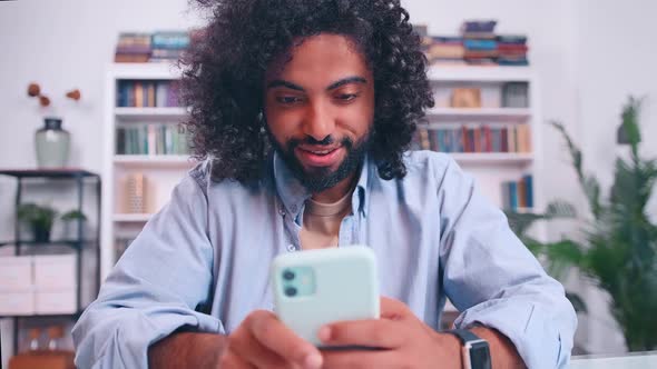 Smiling Middle Eastern Male Hold Smart Phone Use Business Entertainment App