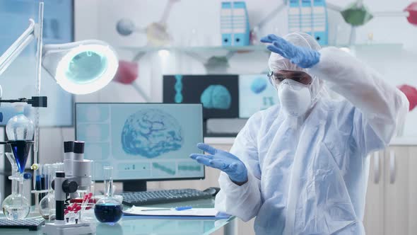 Scientist in Modern Laboratory Wearing AR Glasses Works and Learns in 3D Space