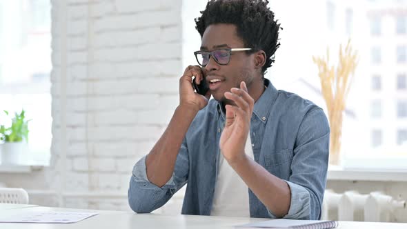 Ambitious Young African Man Talking on Smartphone 