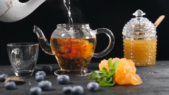 Pouring Boiled Water in Glass Tea Pot