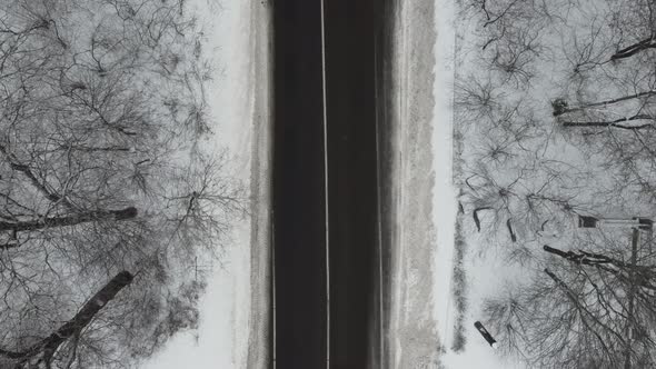 Aerial View of Winter Road Trough Snow Covered Forest