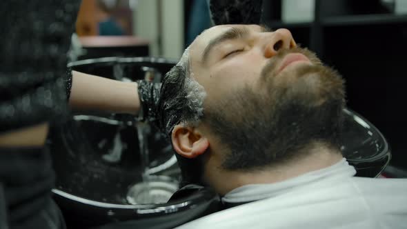 Closeup of a Head Wash in a Barber Shop with Gloves on