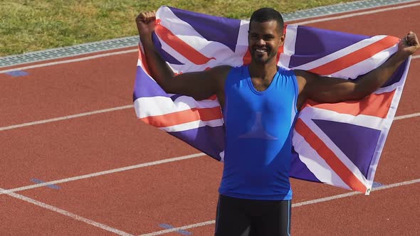 Happy Athlete Holding Flag of His Country in Hands, Britain Is Proud of Winner