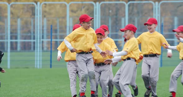 Baseball at School a Team of Boys Baseball Players in Yellow Uniforms Get Hugs and Rejoices in