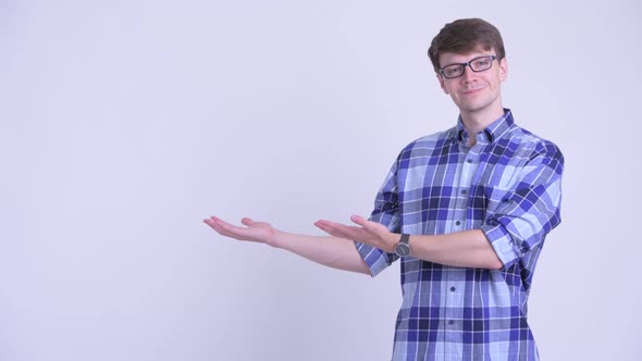 Happy Young Handsome Hipster Man Showing Something