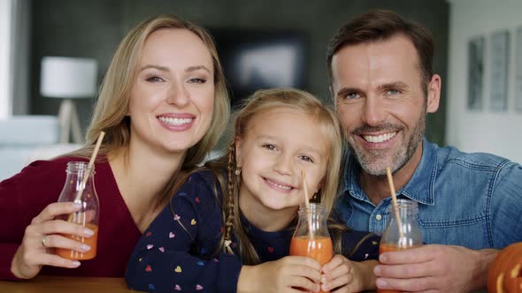 Portrait of smiling family drinking smoothie