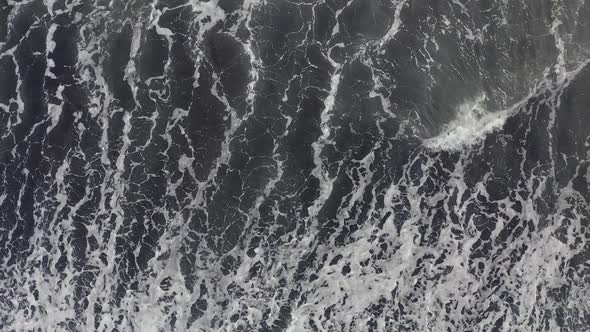 Aerial Top View Beautiful Nature of Volcanic Black Sand Beach and Giant Waves