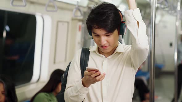 Businessman Using Mobile Phone on Public Train