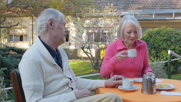 Elderly Couple Having Breakfast Outdoor