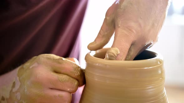 Experienced Potter Creating a Beautiful Clay Vase Using Professional Tools