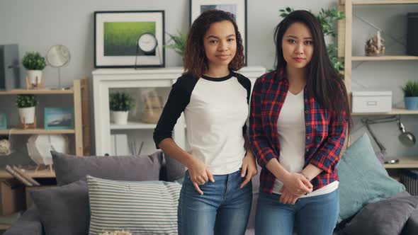 Portrait of Beautiful Young Women Asian and African American Standing at Home Together