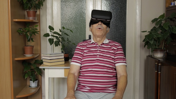 Senior Grandfather Man in Virtual Headset Glasses Watching 3d Video in 360 Vr Helmet at Home