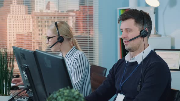 Handsome Man Service Operator Talking To the Client on Phone in Call Center