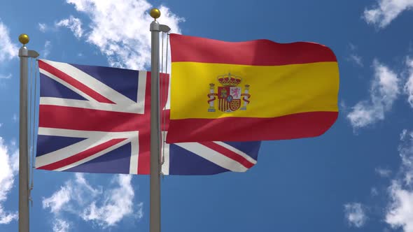 United Kingdom Flag Vs Spain Flag On Flagpole