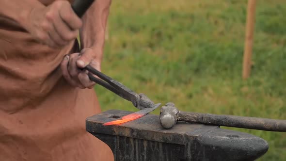 Blacksmith Working with Metal on Anvil Outdoor - Slow Motion, Close Up
