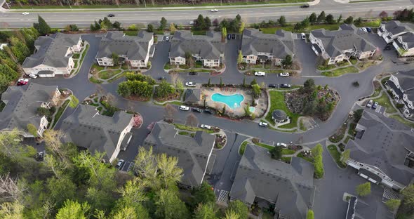 Establishing aerial view of an apartment community with a pool and clubhouse.