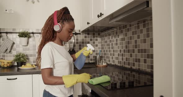 African American Woman Cleaning Stove