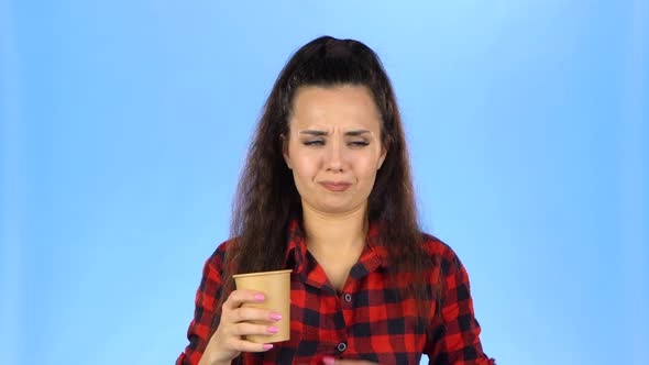 Young Woman Drinking From the Glass Something Not Tasty