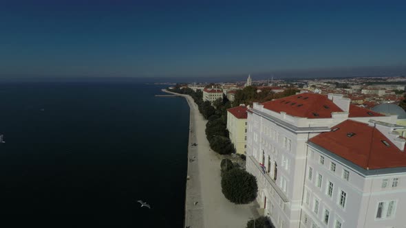 Aerial of white buildings by the sea