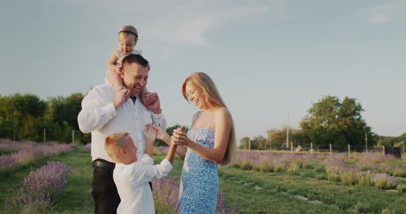 Portrait of a Happy Family in a Lavender Field Their House in the Distance