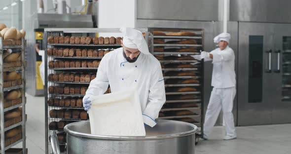 Young Chef Baker with a Beard Preparing the Dough