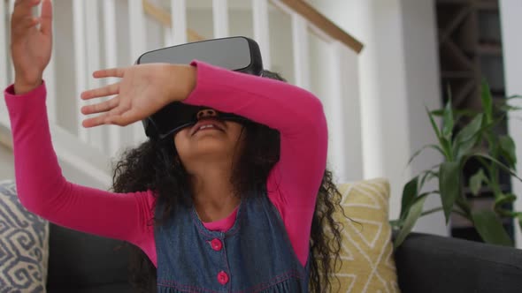 African american girl wearing vr headset and having fun